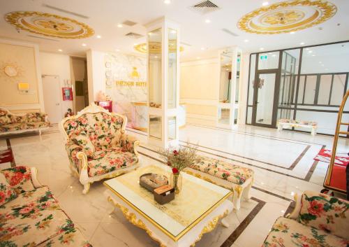 a living room with couches and a coffee table at Dezon Hotel in Quy Nhon