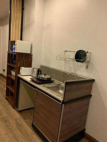 a kitchen with a sink and a counter top at SLEEP MIND in Bangkok