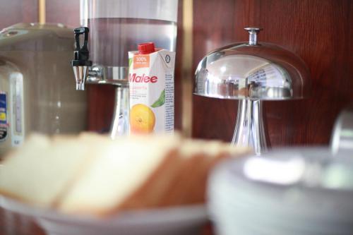 a kitchen counter with a mixer and a bottle of orange juice at Vang Vieng Garden Resort in Vang Vieng