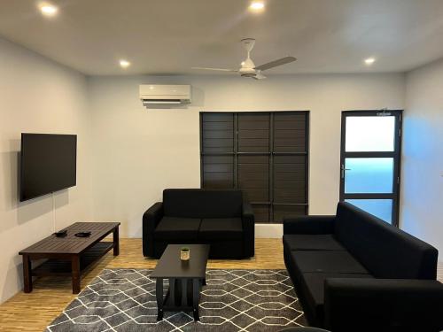 a living room with a couch and a chair at Garden Apartments in Nadi