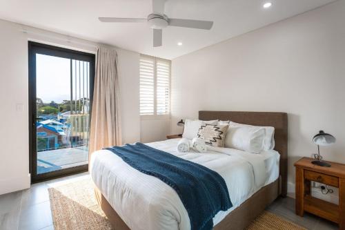 a bedroom with a bed and a large window at Ishtar Apartment 1 Luxury Living Accommodation in Huskisson