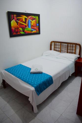 a bed in a room with a painting on the wall at Hotel Las Vegas by CMS hotels in Santa Marta