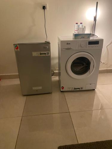 a washing machine sitting next to a washer at Your Studio Near Airport and all in Abu Dhabi