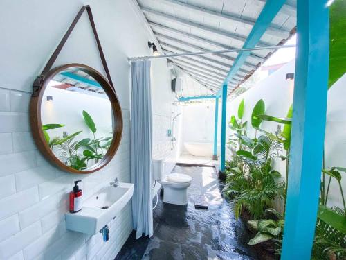 a bathroom with a mirror and a sink at Ubu Villa Prambanan - 3 Bedrooms Villa near Prambanan Temple in Prambanan
