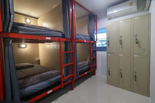 a room with three bunk beds and a closet at No.9 Hostel kanchanaburi in Ban Don Rak
