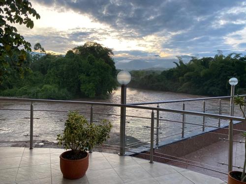 a balcony with a view of a river at Hotel Cascada Cristalina in Melgar