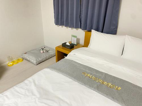 a bedroom with a bed and a table with a night stand at Suanbo Hot Spring Healing Hotel in Chungju