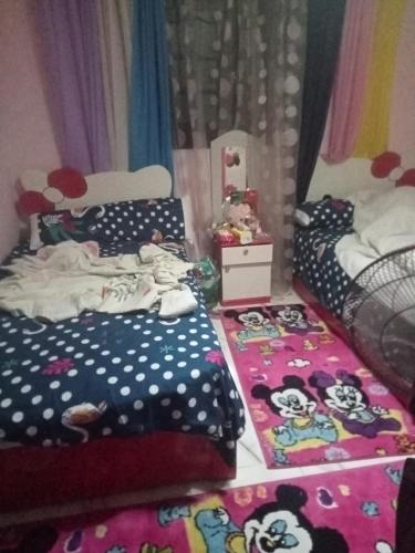 ein Schlafzimmer mit einem Mäusebett und zwei Teppichen in der Unterkunft NourEl-lslam rental in Alexandria
