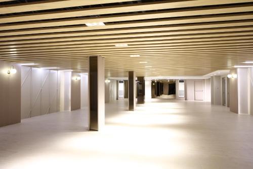 an empty hallway in an office building with wooden ceilings at City Garden Suites Manila in Manila