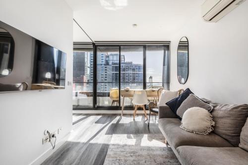 a living room with a couch and a table at Riverview Suites by EdgeTrip in Melbourne