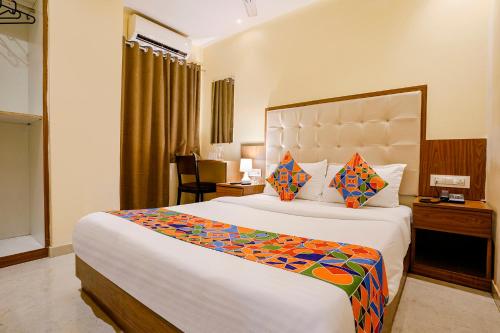 a bedroom with a large bed in a hotel room at FabExpress Wynd in Mumbai
