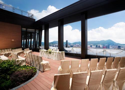 a banquet hall with tables and chairs on a balcony at Harbour Grand Hong Kong in Hong Kong