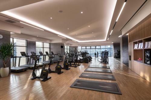 a gym with treadmills and exercise equipment in a building at DoubleTree By Hilton Seoul Pangyo Residences in Seongnam