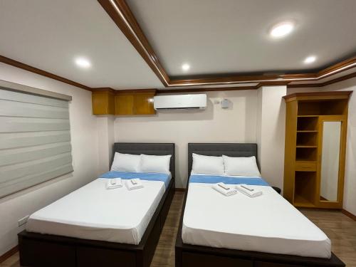 two beds in a small room in a boat at The Legacy Hotel in Tayabas