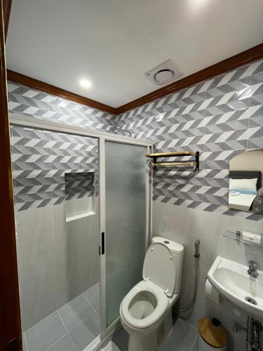 La salle de bains est pourvue d'une douche, de toilettes et d'un lavabo. dans l'établissement The Legacy Hotel, à Tayabas