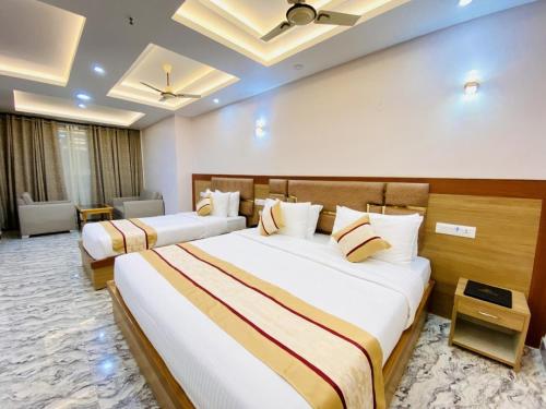 a hotel room with two beds in a room at Hotel Imolesh Imphal in Imphal