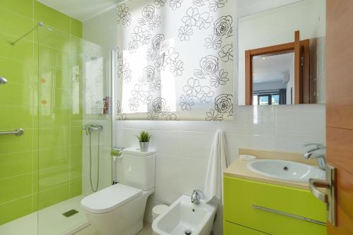 a bathroom with a toilet and a sink and a shower at APARTMENT TIMPLE Puerto del Carmen in Puerto del Carmen