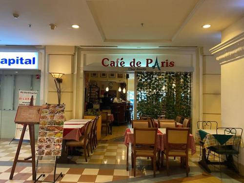 a cafe de paris restaurant with tables and chairs at Lovely 3-Bedroom rental unit in Jakarta