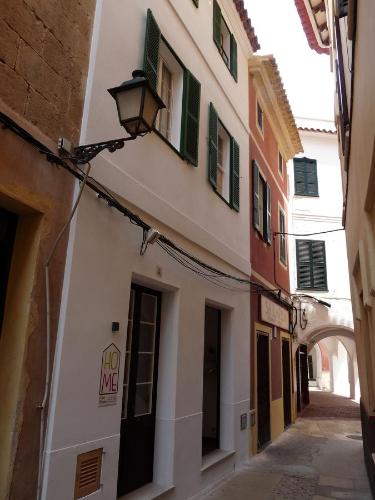 an alley with a building with a street light at HoMe Hotel Menorca in Ciutadella