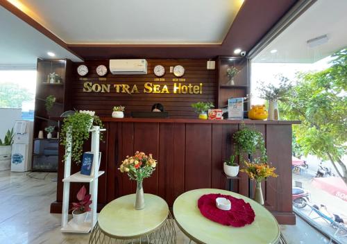 a room with two tables with flowers on it at Sontra Sea Hotel in Danang