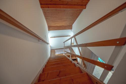 a staircase in a house with wooden floors and wooden ceilings at XLSuite Apartment Superior in Piešťany