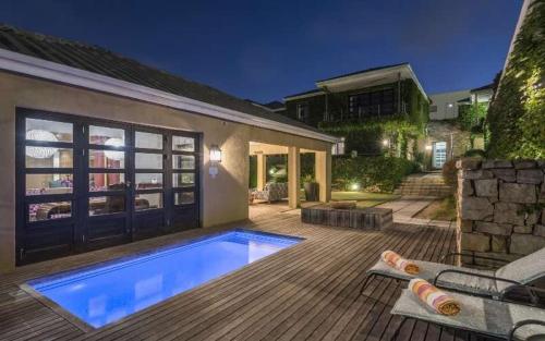 a backyard with a swimming pool and a house at The Windermere Hotel in Summerstrand