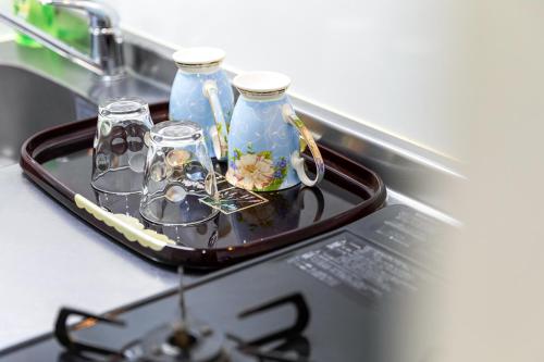 a tray with two glass vases on a counter at Tenjin Minami San Ban Kan in Fukuoka