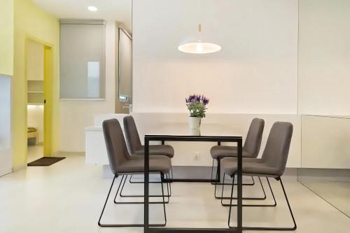 a dining room with a table and chairs at Straits Garden Suites Penang in Jelutong