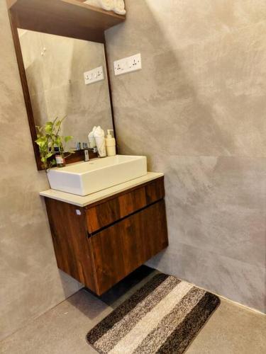 a bathroom with a sink and a mirror at The Turquoise Letterbox - Twin at Central in Kolkata