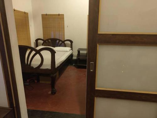 a bedroom with a bed in a room with a door at The Turquoise Letterbox - Twin at Central in Kolkata