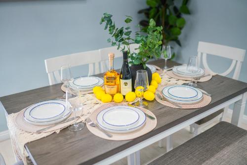 a table with plates and wine bottles and glasses at Retreat Minutes To LAX, Manhattan/ Redondo Beach in Torrance