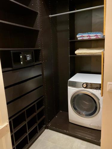 a laundry room with a washer and a washing machine at Palatial Flat inside Bright Duplex Penthouse in Valletta