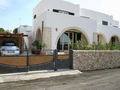 a house with a fence in front of it at Holiday home 400 meters from the sea near Gallipoli in Nardò