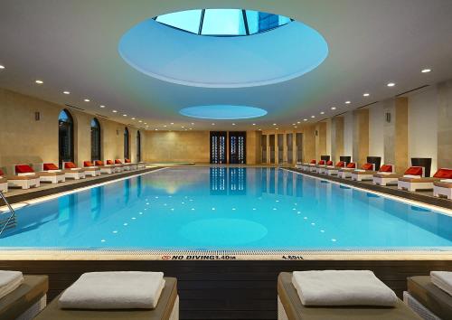 a large swimming pool with a skylight in a hotel at Sheraton Batumi Hotel in Batumi