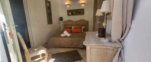 a small bedroom with a bed and a chair at Petra-Bianca in Bonifacio