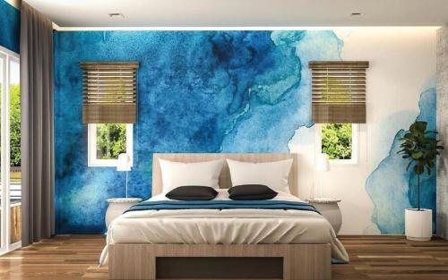a bedroom with a blue wall and a bed at Ko Lanta Amantra Lake View Resort in Ko Lanta