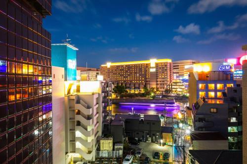 a view of a city at night with buildings at Tenjin Minami San Ban Kan in Fukuoka