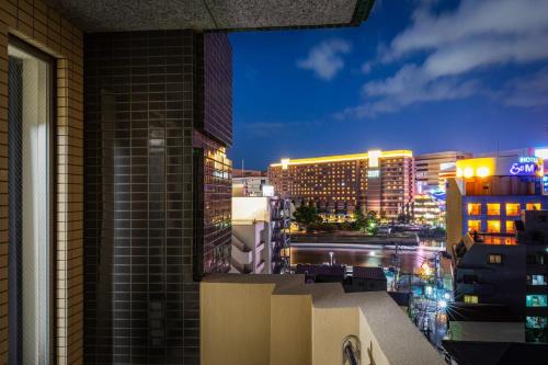 a view of a city skyline at night at Tenjin Minami San Ban Kan in Fukuoka