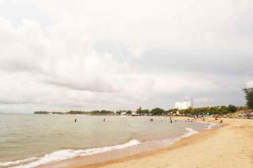 a group of people in the water at a beach at Lucky Star Ho Tram Hotel & Restaurant in Ho Tram
