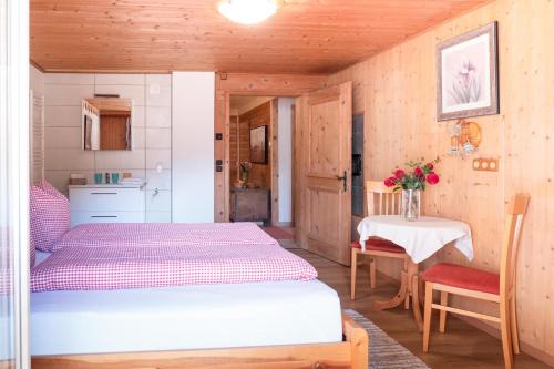 a small bedroom with a bed and a table at Alte Bildhauerei in Aurach bei Kitzbuhel
