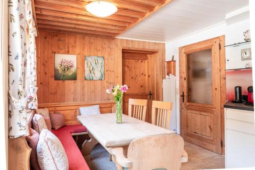 a kitchen and dining room with a table and chairs at Alte Bildhauerei in Aurach bei Kitzbuhel