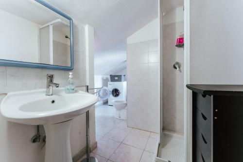 a bathroom with a sink and a toilet at Casa Vacanze Villa Carola in Quartu SantʼElena