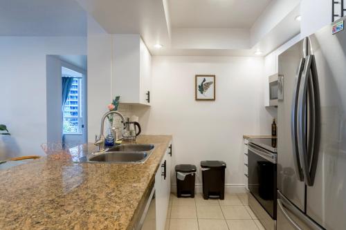 a kitchen with a sink and a refrigerator at Near Yonge Finch Subway 2Bed 2Bath Condo Free Parking in Toronto