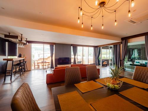 a dining room and living room with a dining table at Grand Penthouse by Grand Orlov Apart in Patong Beach