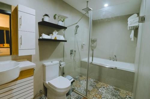 a bathroom with a toilet and a shower and a sink at Davao Rental - AEON Towers Condo 1BR Suite 1Bathroom with Bathtub, Kitchen, Living Room in Davao City