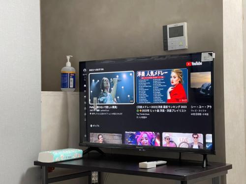 a flat screen tv sitting on top of a table at TokyoGuest Akihabara in Tokyo