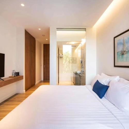 sypialnia z dużym białym łóżkiem i łazienką w obiekcie sea view villa1 w mieście Kata Beach