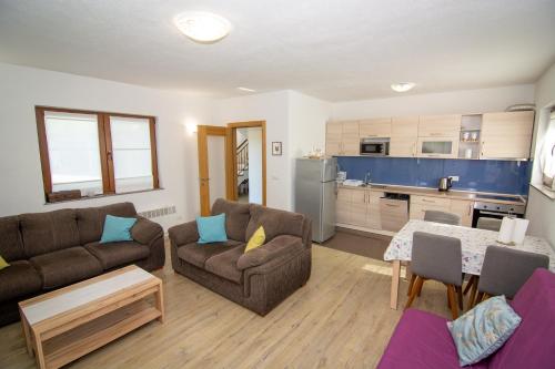 a living room with two couches and a kitchen at Oasis of peace in Bihać