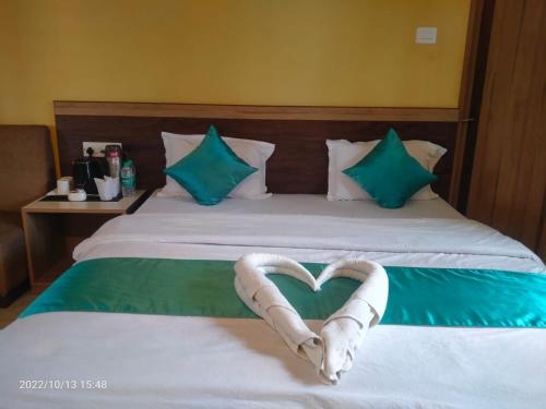 a bed with a heart made out of towels at Sundarban Tiger Roar Resort in Purbbadulki