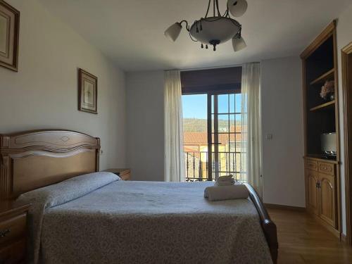 a bedroom with a bed and a large window at Vibes Coruña- Muxía in Castelo